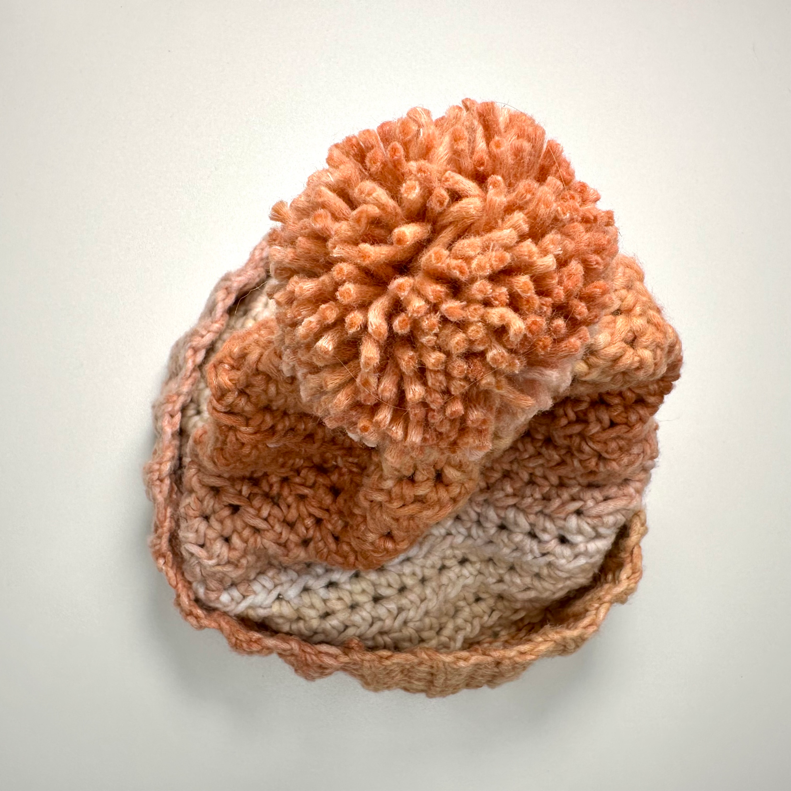 a crochet beanie with a pom pom