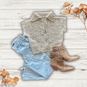 a handmade crochet vest next to some jeans and boots