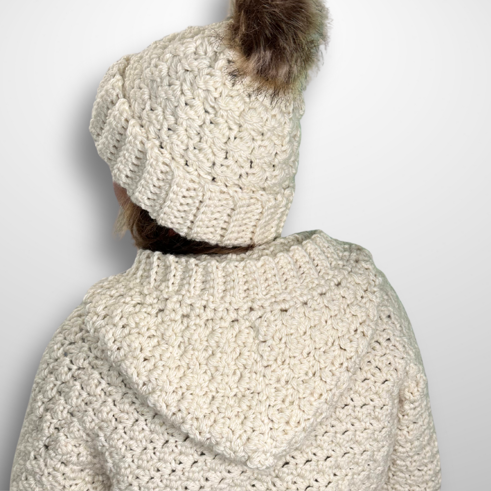 a woman wearing a handmade crochet cardigan and beanie