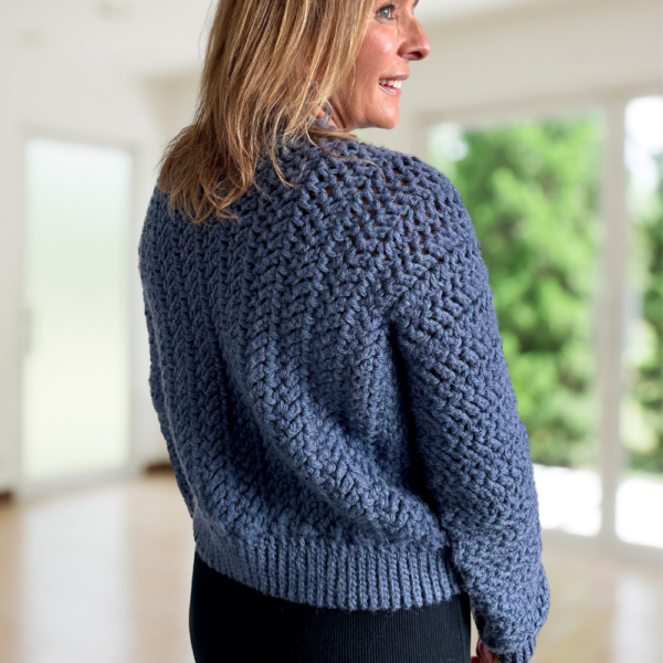 a woman wearing a crochet cardigan