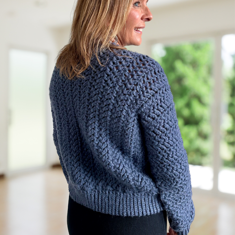 a woman wearing a crochet cardigan