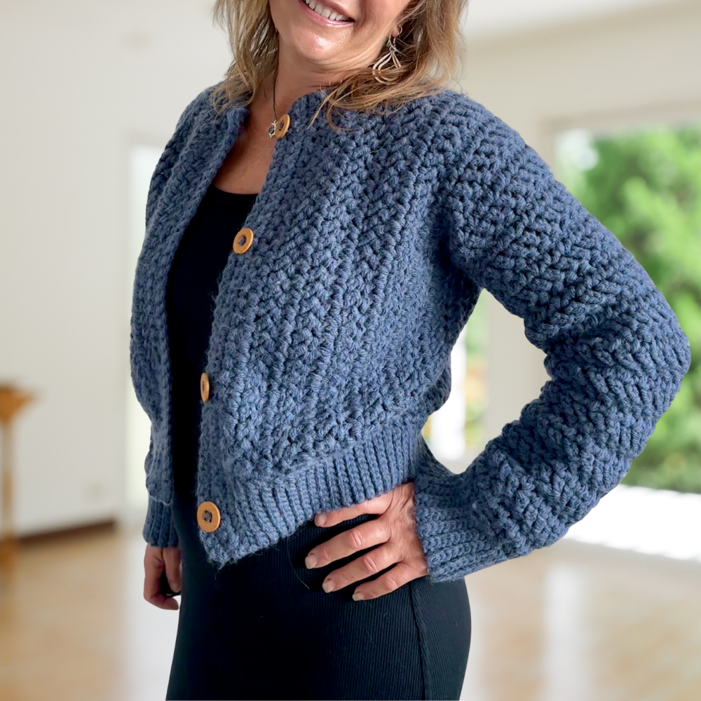 a woman wearing a crochet cardigan
