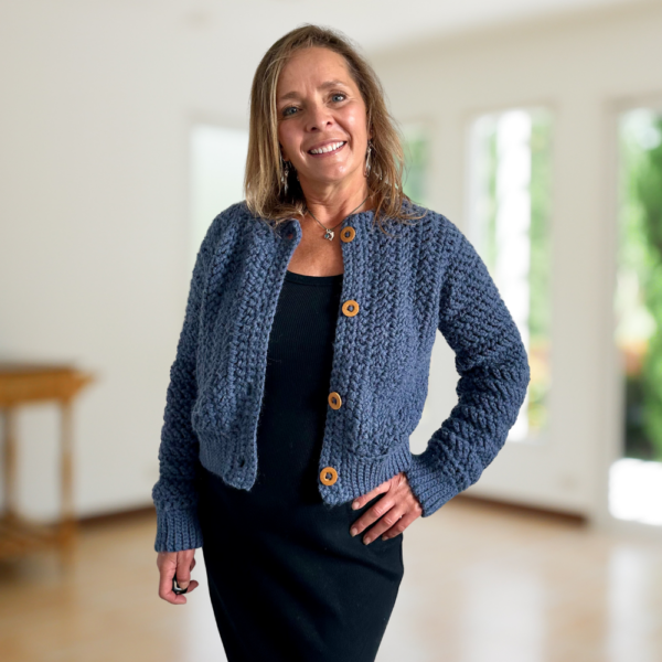 a woman wearing a crochet cardigan