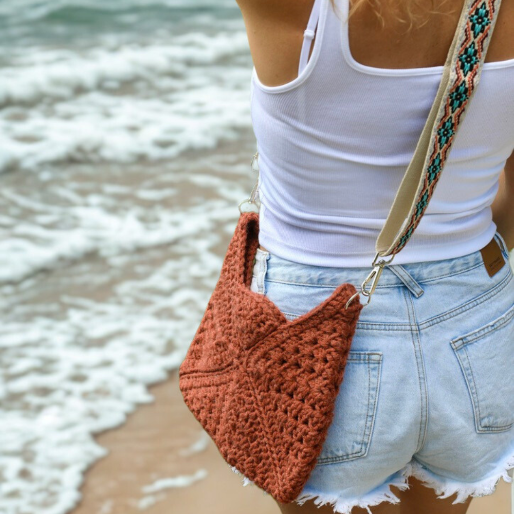 a woman carrying a crochet bag