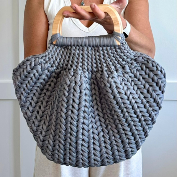 a woman carrying a crochet bag