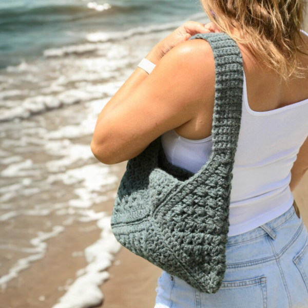 a woman carrying a crochet bag