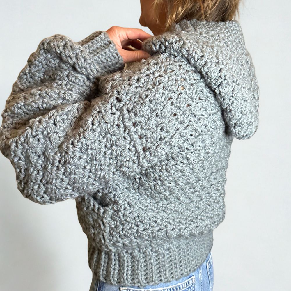 a woman wearing a handmade crochet cardigan