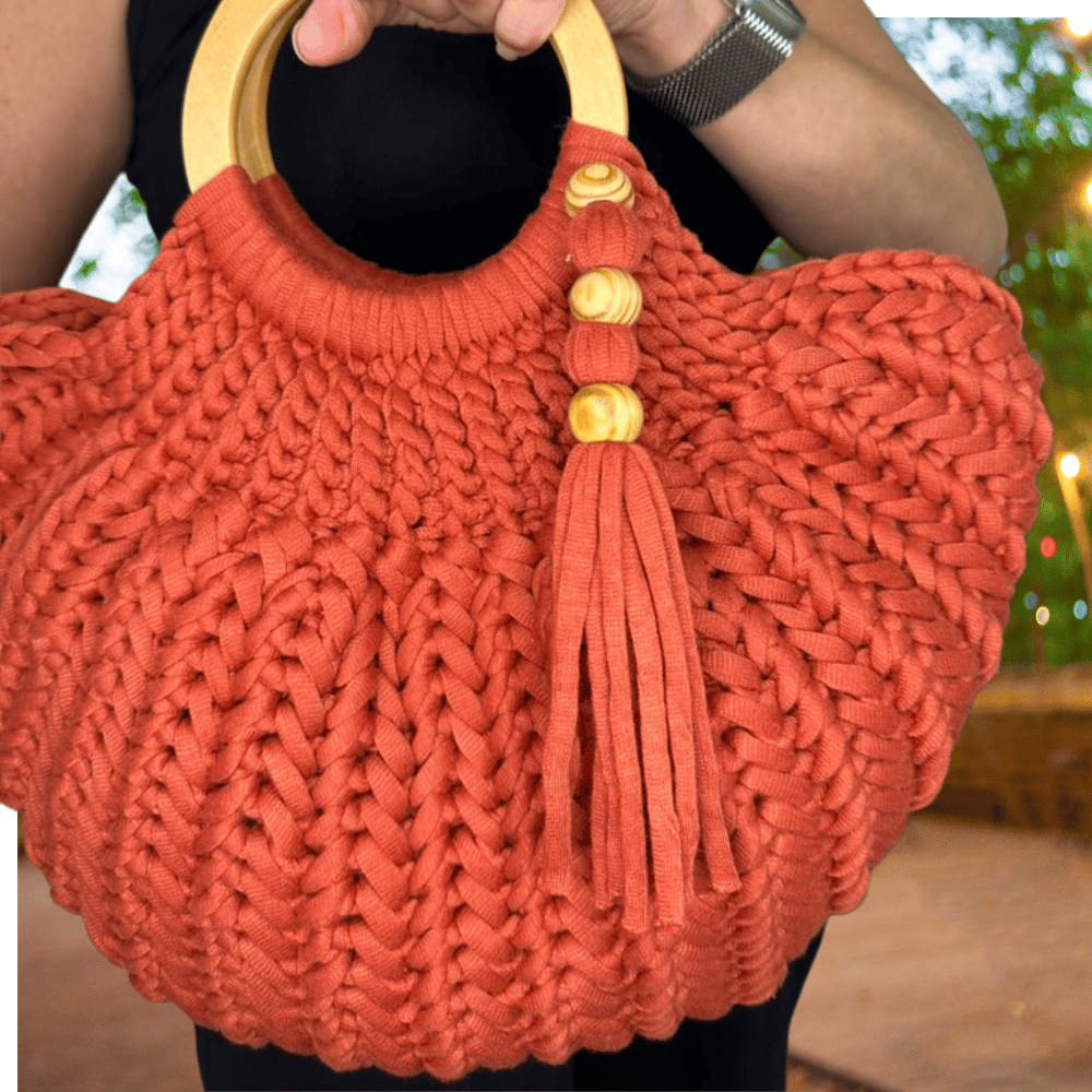 a woman carrying a crochet bag