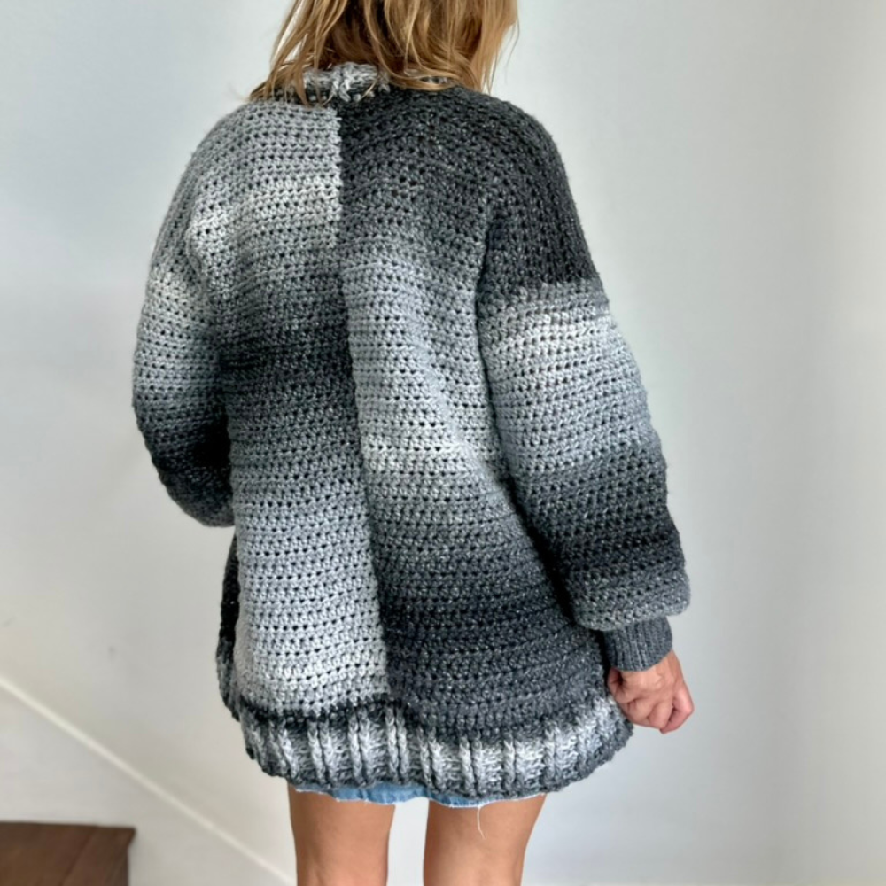 a woman wearing a crochet cardigan