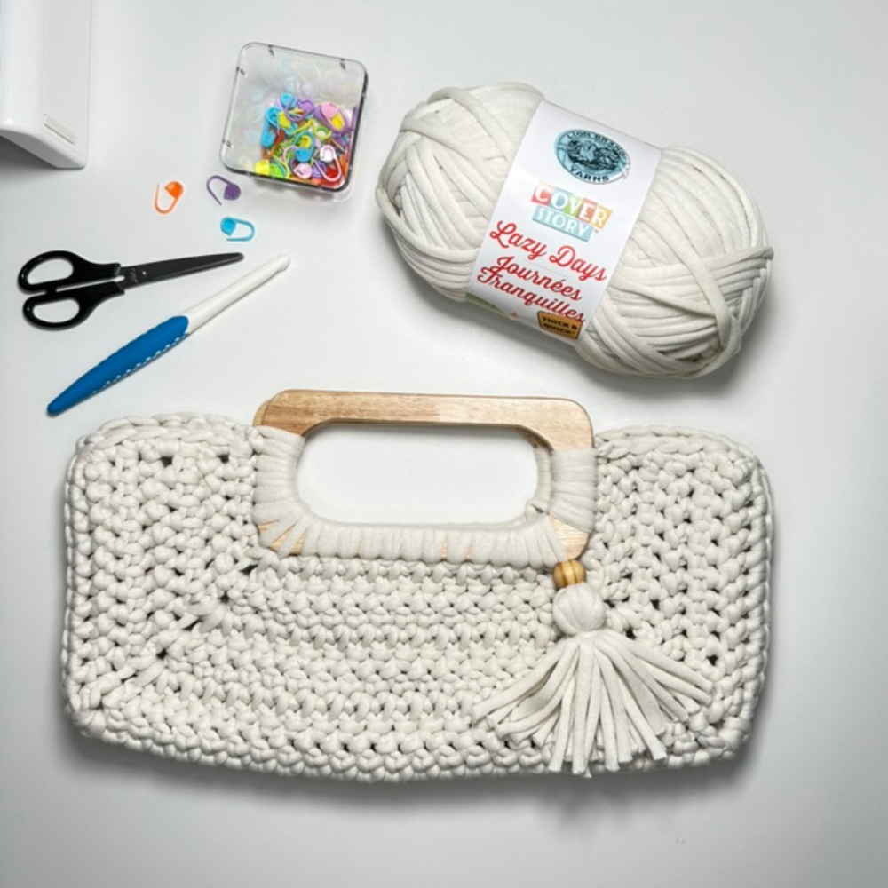 a crochet bag with materials to make it with