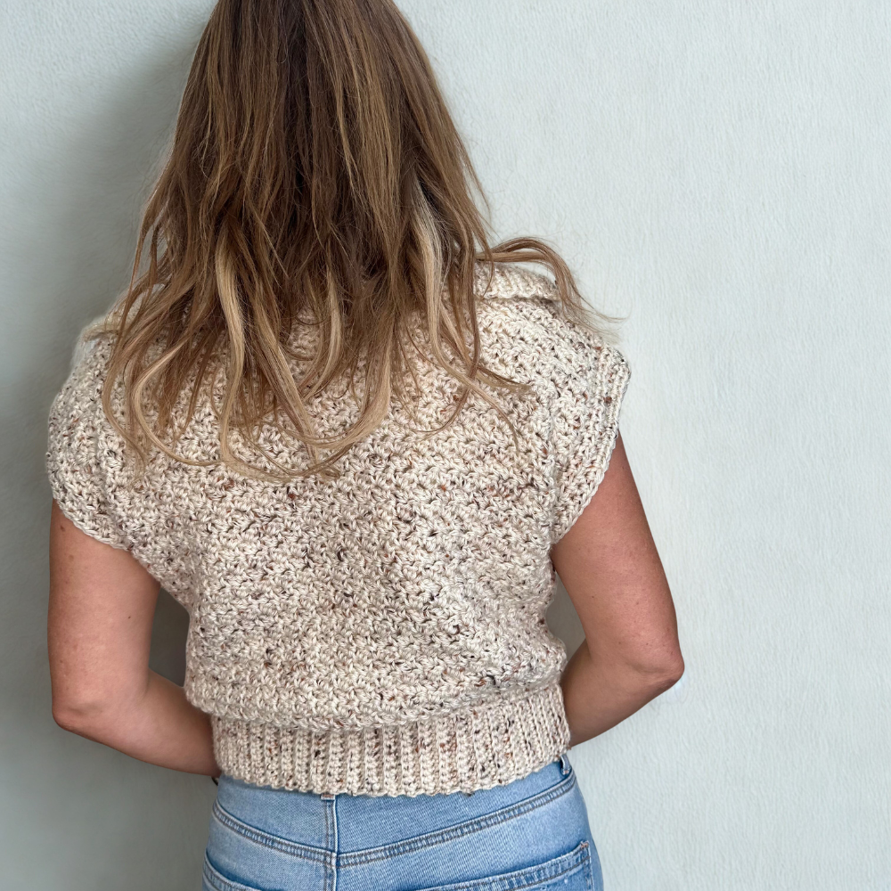 a woman wearing a handmade crochet vest