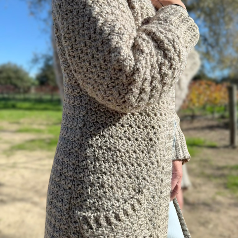 a woman wearing a handmade crochet cardigan