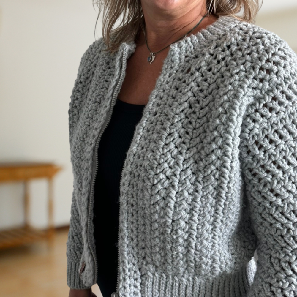 a woman wearing a crochet cardigan