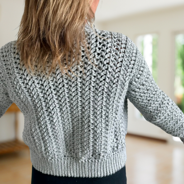 a woman wearing a crochet cardigan