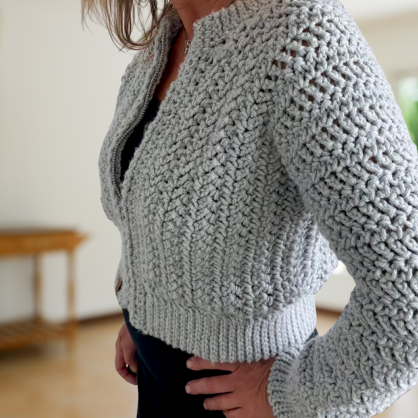 a woman wearing a crochet cardigan